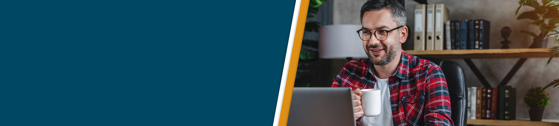 Man looking at Beacon Funding 100% Financing offer on computer smiling