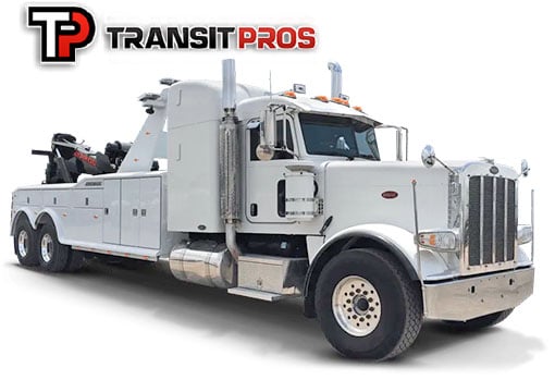 White flatbed tow truck sits in front of a white background.