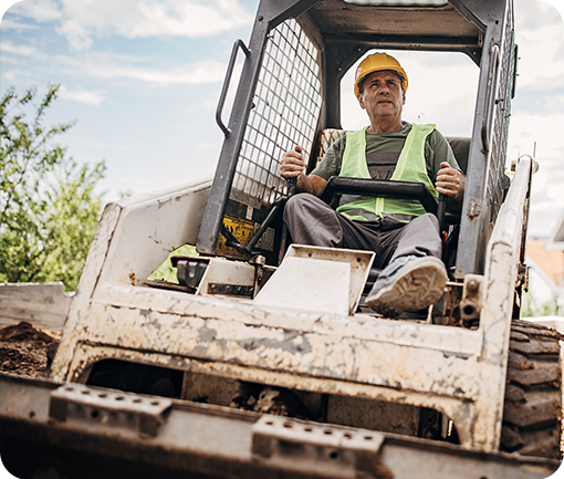 man in skid steer doing landscaping