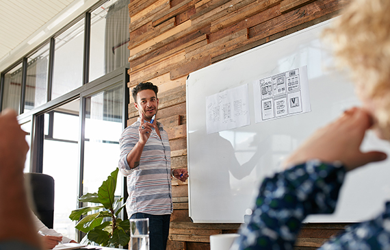 Entrepreneur writes on a whiteboard about his seasonal business.