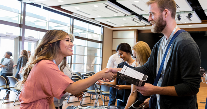 A smiling business owner shakes hands with a friendly Beacon Funding financing consultant. A smiling business owner shakes hands with a friendly Beacon Funding financing consultant.