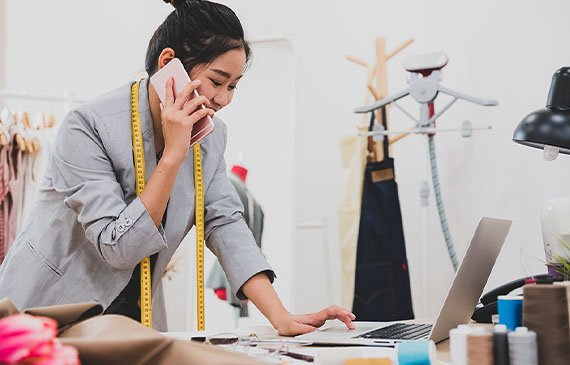 A smiling business owner is smiling after hearing her embroidery business was pre-approved for affordable equipment financing. A smiling business owner is smiling after hearing her embroidery business was pre-approved for affordable equipment financing.