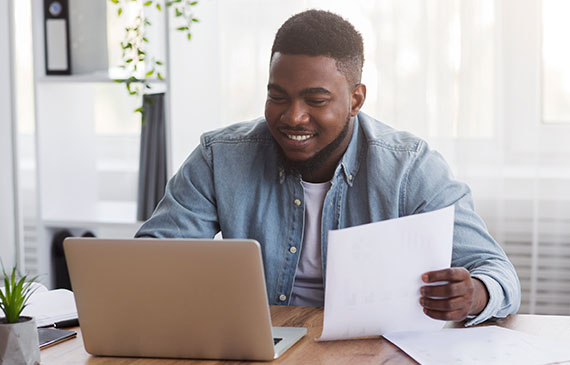 A septic truck business owner checks his savings account after using equipment financing. A septic truck business owner checks his savings account after using equipment financing.