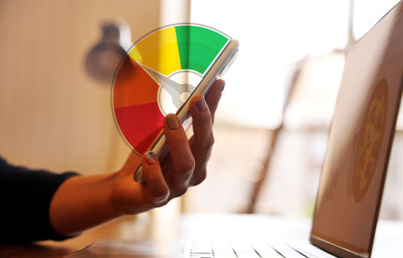 A business owner checks her personal credit score to measure the strength of her business's equipment financing application. A business owner checks her personal credit score to measure the strength of her business's equipment financing application.