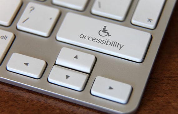 A white computer keyboard shows an accessbility button.
