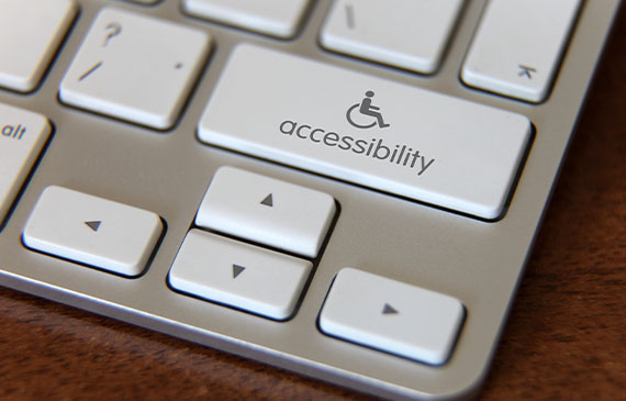 A white computer keyboard shows an accessbility button. A white computer keyboard shows an accessbility button.