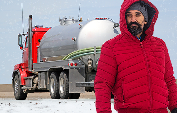 Business owner stands in front of his septic vacuum truck in the middle of winter. Business owner stands in front of his septic vacuum truck in the middle of winter.