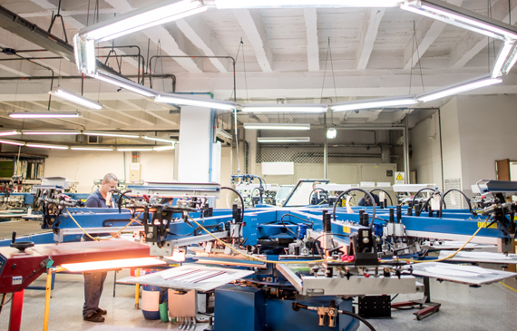 An operator calibrates an automatic screen printing machine for his next round of tshirt prints that was financed by Beacon Funding. An operator calibrates an automatic screen printing machine for his next round of tshirt prints that was financed by Beacon Funding.