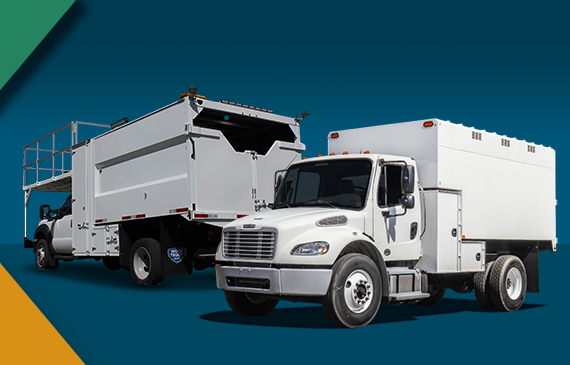 Two large, white forestry bucket trucks sit on a level plain next to each other with a blue background. Their chipper bodies are large, wide, and look like they have enough room to fill large amounts of mulch and chipped debris.
