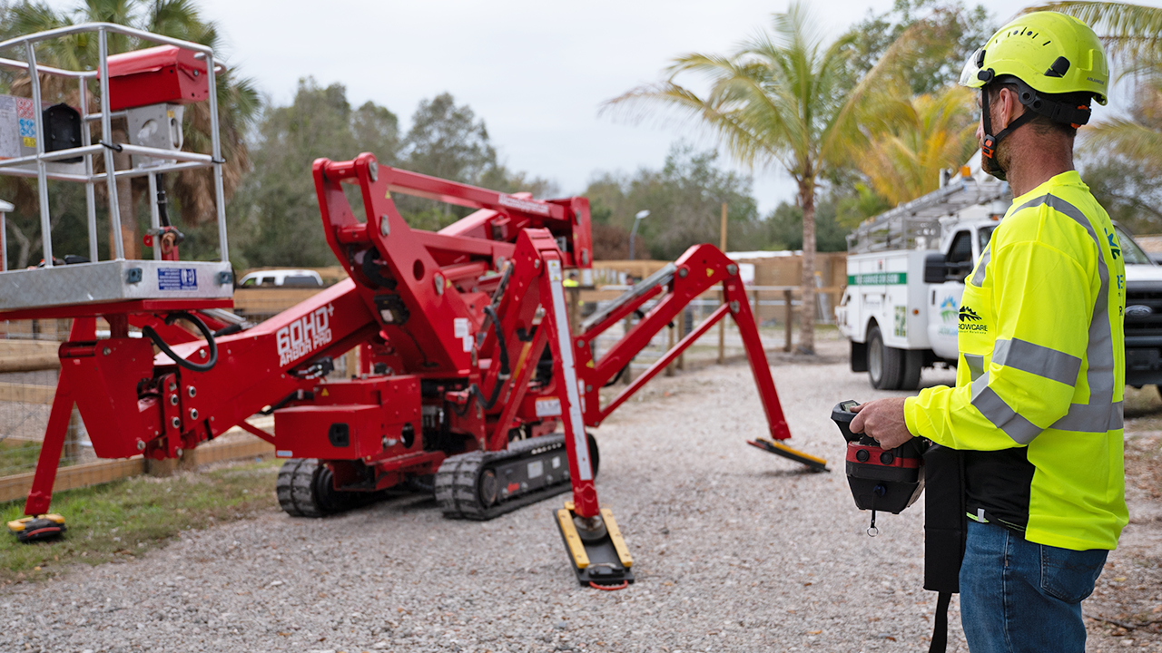 A crew member of Grow Care Outdoor Solutions prepares the spider lift CMC S19HD Pro financed by Beacon Funding for a landscaping job. A crew member of Grow Care Outdoor Solutions prepares the spider lift CMC S19HD Pro financed by Beacon Funding for a landscaping job.
