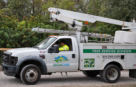 A white forestry bucket truck financed by Beacon Funding drives down a road to the next job for Grow Care Outdoor Solutions. A white forestry bucket truck financed by Beacon Funding drives down a road to the next job for Grow Care Outdoor Solutions.