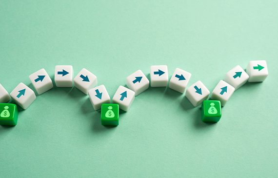 White cubes with blue arrows gradually progressing toward green cubes marked with dollar symbols, illustrating financial movement and business growth. Represents how Beacon Funding’s equipment financing options help companies move efficiently toward profitability by spreading costs, protecting cash reserves, and enabling faster equipment acquisition.