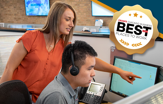 Beacon Funding employees work together on the computer with an equipment financing customer.