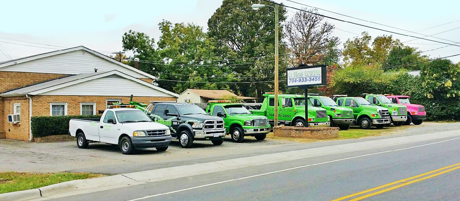 A fleet of eight tow trucks sit outside Lebleu's Towing service.