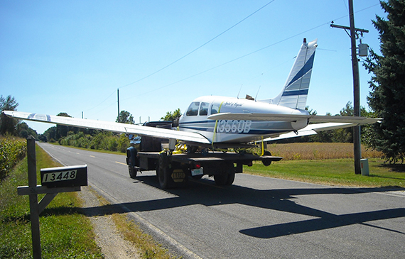 A truck towes a small airplane.