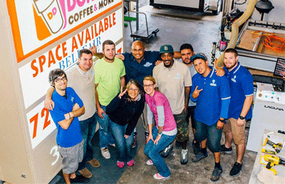 Staff of Awning Boom Truck Financing stand around Chris Wick.