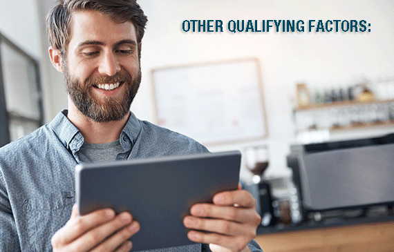 A start-up business owner reviews Beacon Funding's qualifying criteria to get approved for equipment financing on his tablet.