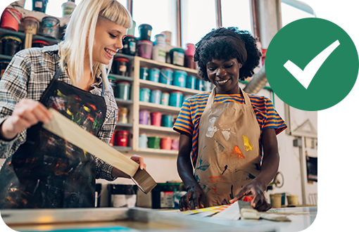 2 women working with screen printing supplies
