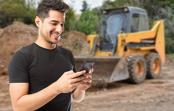 A business owner chats with a financing expert about getting approved for skid steer financing.