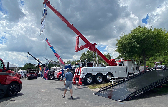 A fleet of heavy wreckers sit in the parking lot at the Florida Tow Show 2023.