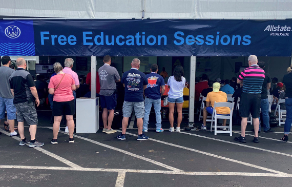 Attendees line up outside the Allstate Roadside tent for a free education session at the Florida Tow Show 2023.
