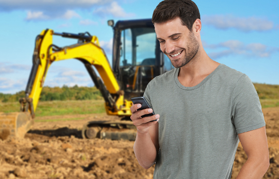 A business owner manages his mini excavator financing using his mobile device and Beacon Funding's mobile app.